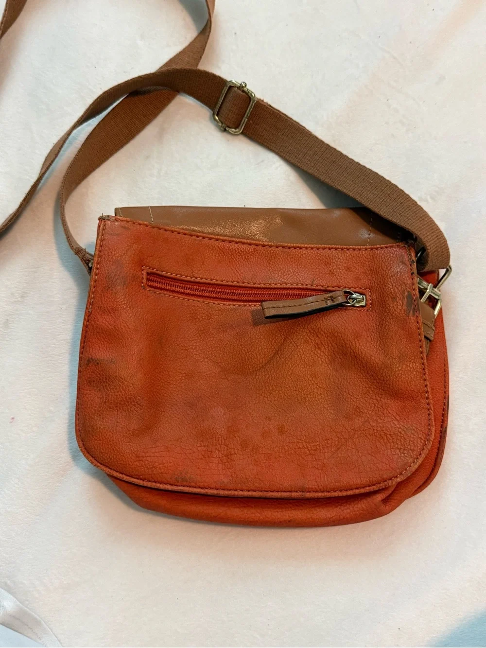 Orange U.S. Polo Assn. leather crossbody bag with brown strap